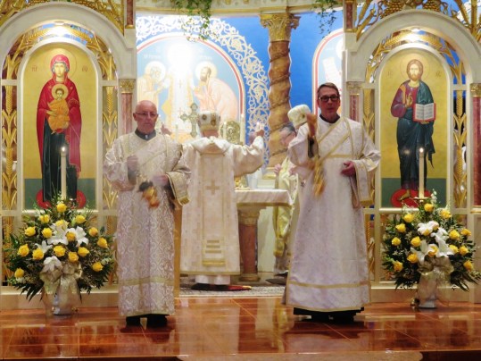 Deacons incense church and faithful during Cherubic Hymn
